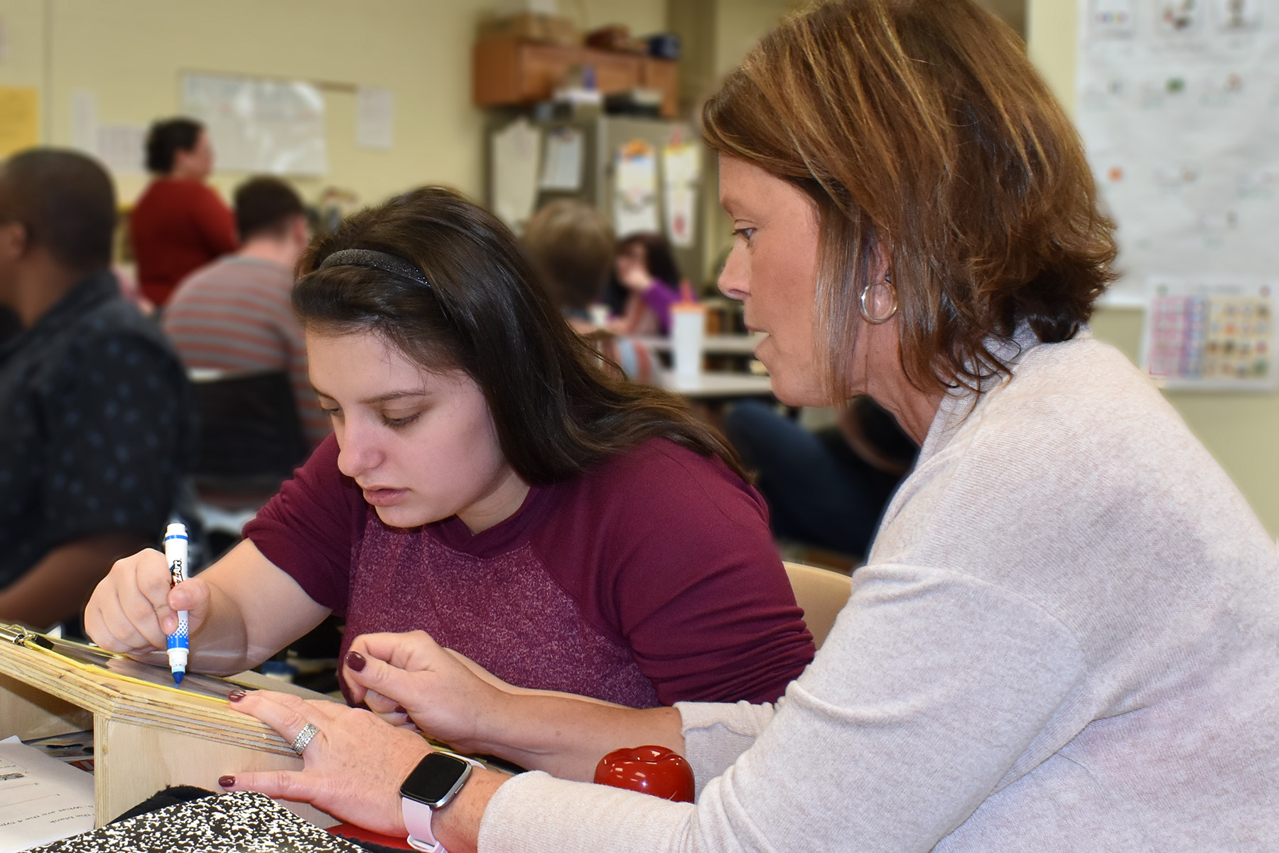 Pictured are Construction Trade students from the Dutchess BOCES Career and Technical Institute and students who use slant boards to improve writing along with occupational therapist Lisa Serlin